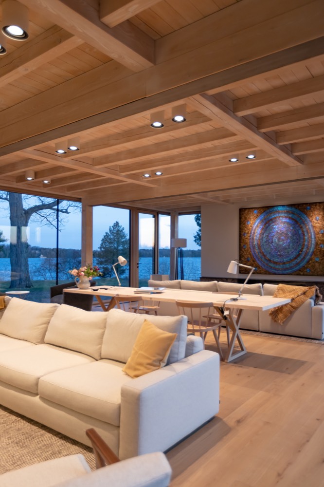 The lakeside living room at Bloom at dusk